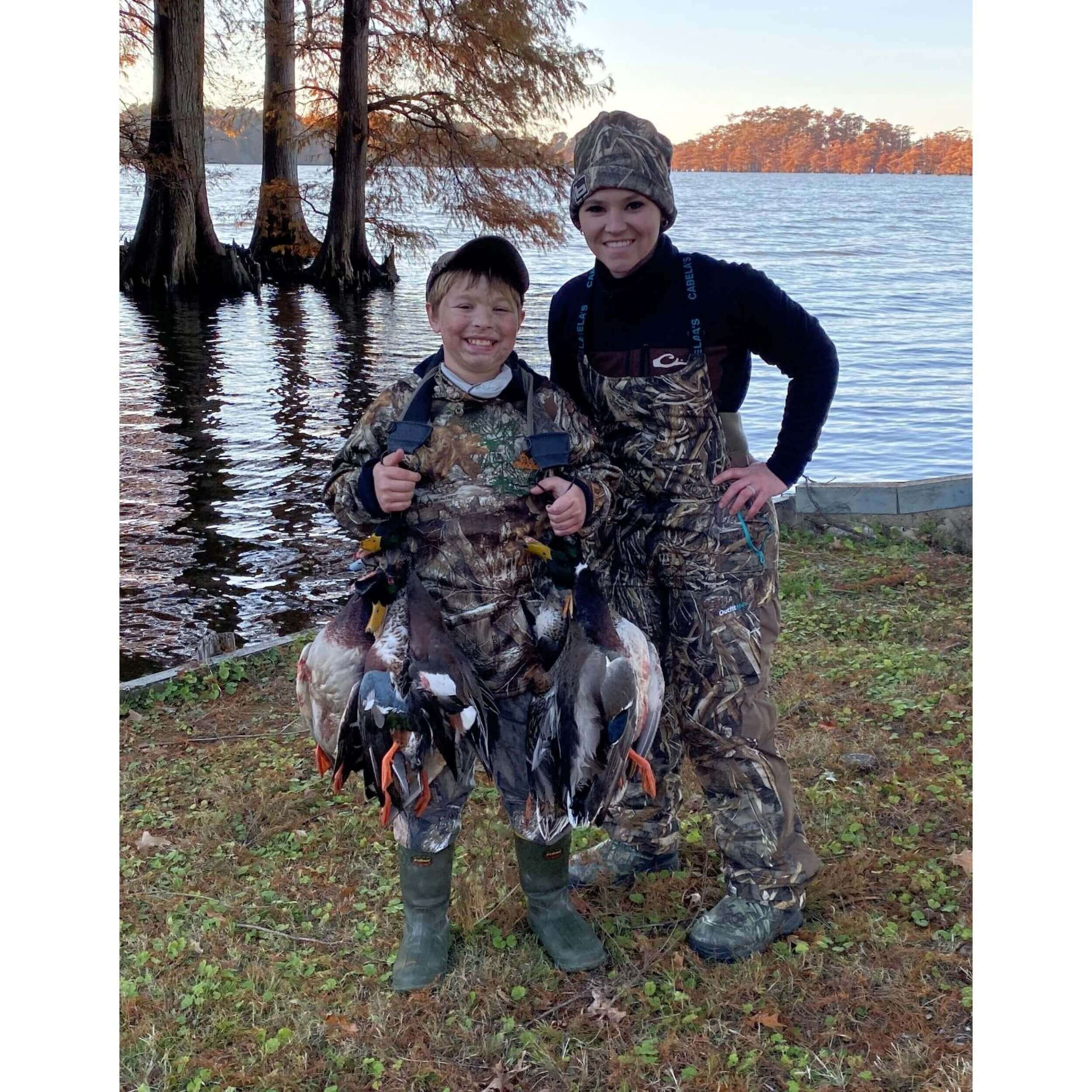 woman and boy with ducks after hunting