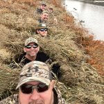 Men taking selfie in duck blind