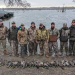 men posing with their ducks after hunt