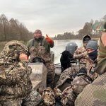 men on boat during duck hunt