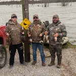 hunters posing together after duck hunt
