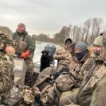 hunters on boat during duck hunt