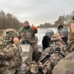 hunters on boat during duck hunt