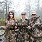3 hunters holding ducks