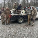 Group of hunters and ducks