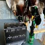 Hunted ducks, a duck call and ammunition