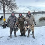 3 hunters holding ducks