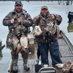 Two hunters with ducks