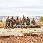 Group of hunters with ducks
